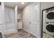 Bathroom with shower-tub combo and stacked washer and dryer at 6119 N 18Th Dr, Phoenix, AZ 85015