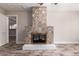 Living room with wood-look tile flooring and decorative fireplace with accent tile at 6119 N 18Th Dr, Phoenix, AZ 85015