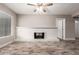 A simple living room featuring wood-look tile flooring, a cozy fireplace, and ample natural light at 6119 N 18Th Dr, Phoenix, AZ 85015
