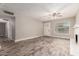Bright living room with a brick fireplace, wood-look tile flooring, and an open layout at 6119 N 18Th Dr, Phoenix, AZ 85015
