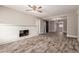 Spacious living room featuring wood-look tile flooring, a cozy fireplace, and ample natural light at 6119 N 18Th Dr, Phoenix, AZ 85015