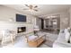 Elegant living room with a brick fireplace, modern furniture, and an open layout leading to the dining area at 6119 N 18Th Dr, Phoenix, AZ 85015