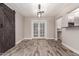 Living room featuring wood-look tile flooring and French doors at 6119 N 18Th Dr, Phoenix, AZ 85015