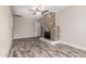 Spacious living room featuring wood-look tile flooring and a decorative fireplace with accent tile at 6119 N 18Th Dr, Phoenix, AZ 85015