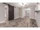 Living room featuring wood-look tile flooring and barn door feature at 6119 N 18Th Dr, Phoenix, AZ 85015