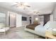 A spacious main bedroom features a barn door closet, a TV, ceiling fans, and neutral decor at 6119 N 18Th Dr, Phoenix, AZ 85015