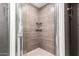 A modern glass enclosed shower with sleek tilework, and a built-in shelf at 6119 N 18Th Dr, Phoenix, AZ 85015