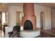 Cozy living room featuring a kiva fireplace, tile base, and an accent chair for relaxing at 6619 E Quail Hideaway E Ln, Gold Canyon, AZ 85119