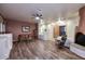 Spacious living room with wood flooring, a brick fireplace, and ample natural light at 6619 E Quail Hideaway E Ln, Gold Canyon, AZ 85119