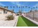 Landscaped backyard with putting green, modern patio furniture, and desert landscaping at 6943 E Granada Rd, Scottsdale, AZ 85257