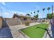 View of the backyard showing the bocce ball court, backyard wall art, and outdoor seating at 6943 E Granada Rd, Scottsdale, AZ 85257