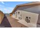 Backyard view of exterior wall with a gated entryway and crushed gravel landscaping at 6943 E Granada Rd, Scottsdale, AZ 85257