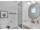 Bathroom featuring a modern vanity, oval mirror, and tiled shower at 6943 E Granada Rd, Scottsdale, AZ 85257