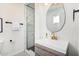 Modern bathroom featuring a vanity with sleek fixtures and a glass-enclosed shower at 6943 E Granada Rd, Scottsdale, AZ 85257