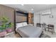 Studio bedroom with a murphy bed, potted plant, and side chairs at 6943 E Granada Rd, Scottsdale, AZ 85257