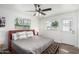 Well-lit bedroom with a queen size bed, neutral bedding, and a view of the backyard at 6943 E Granada Rd, Scottsdale, AZ 85257
