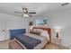 Bright bedroom with a ceiling fan, window, and light hardwood floors at 6943 E Granada Rd, Scottsdale, AZ 85257