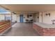Spacious carport with a vibrant blue front door, and a custom brick bbq at 6943 E Granada Rd, Scottsdale, AZ 85257