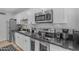 Modern kitchen featuring white cabinets, stainless steel appliances, and stylish backsplash at 6943 E Granada Rd, Scottsdale, AZ 85257