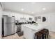 Modern kitchen featuring white cabinets, stainless steel appliances, and a center island with seating at 6943 E Granada Rd, Scottsdale, AZ 85257