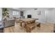 Bright living room featuring modern furniture, a stylish dining table, and wood-look flooring at 6943 E Granada Rd, Scottsdale, AZ 85257
