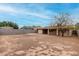 Backyard view features a spacious area with block fencing and a covered patio at 7017 W Beatrice St, Phoenix, AZ 85043