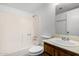 Cozy bathroom featuring a shower-tub combo and single sink vanity with wood cabinetry at 7017 W Beatrice St, Phoenix, AZ 85043
