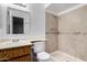 Cozy bathroom with tiled shower, classic vanity, and ample lighting at 7017 W Beatrice St, Phoenix, AZ 85043