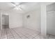 Bright bedroom featuring tiled flooring, a ceiling fan, and a convenient closet space at 7017 W Beatrice St, Phoenix, AZ 85043