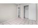 Functional bedroom with tiled floors and a closet for ample storage space at 7017 W Beatrice St, Phoenix, AZ 85043