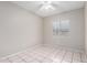 Inviting bedroom with neutral walls, tiled flooring, a window and a ceiling fan at 7017 W Beatrice St, Phoenix, AZ 85043