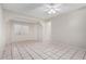 Bright bedroom with tile floors, a ceiling fan, and ample natural light at 7017 W Beatrice St, Phoenix, AZ 85043