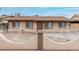 Single-story home boasting a quaint front yard enclosed by a unique decorative metal and masonry fence at 7017 W Beatrice St, Phoenix, AZ 85043