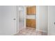 Hallway with wood cabinets and neutral walls leading to a bedroom at 7017 W Beatrice St, Phoenix, AZ 85043