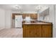 Well-maintained kitchen with wood cabinetry, white appliances, and tile floor at 7017 W Beatrice St, Phoenix, AZ 85043