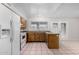 Bright kitchen featuring a functional layout, white appliances and ample counter space at 7017 W Beatrice St, Phoenix, AZ 85043