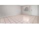 Bright, open living area with tile flooring, a large window, and a fresh, neutral color palette at 7017 W Beatrice St, Phoenix, AZ 85043