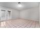 The bright and spacious living room showcases durable tile flooring and direct access to the backyard through glass doors at 7017 W Beatrice St, Phoenix, AZ 85043