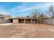 Exterior rear view of single-story home showing the home's covered patio and a spacious backyard at 7017 W Beatrice St, Phoenix, AZ 85043