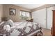 Comfortable bedroom with a large window, warm tones, and a charming quilt at 7920 E Via Camello -- # 48, Scottsdale, AZ 85258