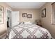 Cozy bedroom featuring a patterned quilt, warm colors, and two framed prints above the headboard at 7920 E Via Camello -- # 48, Scottsdale, AZ 85258