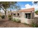 House exterior featuring desert landscaping, neutral stucco, and a red tile roof at 7920 E Via Camello -- # 48, Scottsdale, AZ 85258