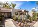 Charming front yard showcasing desert landscaping with cacti, succulents, and a cozy covered patio area at 7920 E Via Camello -- # 48, Scottsdale, AZ 85258