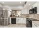 Modern kitchen with stainless steel appliances, white cabinets, and granite countertops for a sleek look at 7920 E Via Camello -- # 48, Scottsdale, AZ 85258