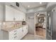 Bright kitchen features white cabinets, granite countertops and modern stainless steel appliances at 7920 E Via Camello -- # 48, Scottsdale, AZ 85258
