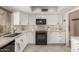Updated kitchen features white cabinets, granite counters, stainless steel appliances and tile flooring at 7920 E Via Camello -- # 48, Scottsdale, AZ 85258