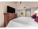 Spacious main bedroom with high ceilings, ceiling fan, large dresser and mounted TV at 7920 E Via Camello -- # 48, Scottsdale, AZ 85258