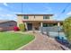Spacious backyard with a green lawn, landscaping, and a pool with a safety fence, perfect for outdoor enjoyment at 8761 W Mary Ann Dr, Peoria, AZ 85382