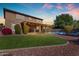 Large backyard showcasing a pool with safety fence, lush lawn, mature landscaping, and covered patio at 8761 W Mary Ann Dr, Peoria, AZ 85382