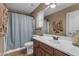 Bathroom featuring a single sink vanity and a shower with blue curtain at 8761 W Mary Ann Dr, Peoria, AZ 85382
